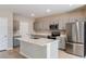 Modern kitchen with stainless steel appliances, gray cabinets, and a large center island at 4075 Gardenia Ave, Lake Hamilton, FL 33851