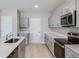 Stylish modern kitchen with stainless appliances, gray cabinets, and bright countertops at 4075 Gardenia Ave, Lake Hamilton, FL 33851