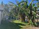 View of the backyard featuring mature banana trees and other beautiful landscaping at 617 Vandenberg St, Altamonte Springs, FL 32701