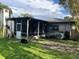 View of the backyard featuring a screened in patio and mature trees at 617 Vandenberg St, Altamonte Springs, FL 32701