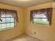 Bedroom with floral curtains by the single pane windows and neutral-colored walls at 617 Vandenberg St, Altamonte Springs, FL 32701