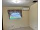 Bedroom with light yellow walls and a floral curtain by the single pane window at 617 Vandenberg St, Altamonte Springs, FL 32701
