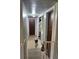 Hallway featuring neutral paint, access to rooms, and a staircase with a baby gate at 617 Vandenberg St, Altamonte Springs, FL 32701