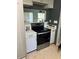 A view of the black stove in the kitchen with stainless steel refrigerator and white cabinets at 617 Vandenberg St, Altamonte Springs, FL 32701