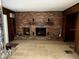 Living room featuring a brick fireplace with wood paneling, suitable for entertaining at 617 Vandenberg St, Altamonte Springs, FL 32701