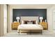 This bedroom features an accent wall, night stands, and a bench at the foot of the bed at 1253 Deepwater Cir, Eagle Lake, FL 33839