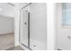 Bathroom with tiled shower, glass doors, and modern fixtures at 13280 Tula Loop, Astatula, FL 34705