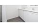 Bathroom vanity with dual sinks, white cabinets and modern fixtures at 13280 Tula Loop, Astatula, FL 34705