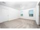 Bright bedroom with neutral carpet, white walls, and two windows providing ample natural light at 13280 Tula Loop, Astatula, FL 34705