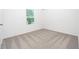 Bedroom with neutral carpet, white walls, and window at 13280 Tula Loop, Astatula, FL 34705