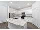 Bright kitchen with white cabinets, granite countertops, stainless steel appliances, and wood-look flooring at 13280 Tula Loop, Astatula, FL 34705