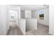 Upstairs hallway with neutral carpet, white walls, and plenty of natural light at 13280 Tula Loop, Astatula, FL 34705