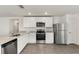 Modern kitchen with white cabinetry, stainless steel appliances, granite counters and plenty of counter space at 1794 White Elephant Loop, Winter Haven, FL 33884