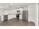 Well-equipped kitchen with white cabinetry, stainless steel appliances, and open layout, perfect for cooking at 1794 White Elephant Loop, Winter Haven, FL 33884