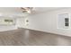 Expansive living space with hard surface flooring, white walls, and large windows for natural light at 1794 White Elephant Loop, Winter Haven, FL 33884