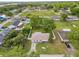 Aerial view showcasing a house with a fenced backyard and mature trees in a neighborhood setting at 2937 Delrose N Dr, Lakeland, FL 33805