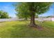 Spacious backyard featuring mature trees, a white vinyl fence, and a storage shed at 2937 Delrose N Dr, Lakeland, FL 33805