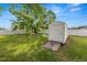 Backyard featuring a storage shed with a ramp and a surrounding white fence at 2937 Delrose N Dr, Lakeland, FL 33805
