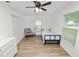 Well-lit bedroom with neutral paint, wood-look floors, and modern ceiling fan at 2937 Delrose N Dr, Lakeland, FL 33805