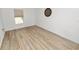 Neutral bedroom has wood-look flooring, natural light, and blank canvas appeal at 2937 Delrose N Dr, Lakeland, FL 33805
