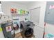 Laundry room with storage shelves, modern washer, and neutral paint at 2937 Delrose N Dr, Lakeland, FL 33805