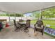 Covered patio ready for entertaining with patio set at 2937 Delrose N Dr, Lakeland, FL 33805