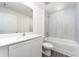 Bathroom with modern design featuring white cabinets, sink, countertops, toilet and tub at 3183 Seville St, Lake Alfred, FL 33850