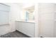 White cabinets and countertops bathroom with modern fixtures and walk in closet at 3183 Seville St, Lake Alfred, FL 33850