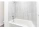 New bathtub with tile backsplash and shower head, perfect for relaxing at 3183 Seville St, Lake Alfred, FL 33850