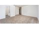 Spacious carpeted bedroom with white walls and trim and attached bathroom at 3183 Seville St, Lake Alfred, FL 33850