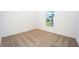 Bedroom featuring a window letting in natural light and neutral carpeting at 3183 Seville St, Lake Alfred, FL 33850