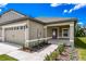 Home showcasing a side entry with a plum colored door and lovely landscaping at 3183 Seville St, Lake Alfred, FL 33850