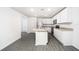 Clean kitchen with white cabinetry, island with sink, and stainless steel appliances at 3183 Seville St, Lake Alfred, FL 33850