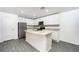 Bright kitchen features white cabinetry, stainless steel appliances, and a center island at 3183 Seville St, Lake Alfred, FL 33850