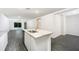 Open kitchen showcasing granite countertops, island with sink, and modern appliances at 3183 Seville St, Lake Alfred, FL 33850