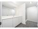 Bright bathroom featuring a large mirror, white vanity with storage, and a glass-enclosed shower with stylish gray tiling at 3736 Bergamot St, Lake Alfred, FL 33850