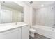 Bathroom featuring a white vanity, a tub with stylish tile surround, gray flooring, and recessed lighting at 3736 Bergamot St, Lake Alfred, FL 33850
