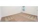 Carpeted bedroom featuring a window, white walls, and ample natural light at 3736 Bergamot St, Lake Alfred, FL 33850