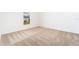 Empty bedroom with neutral carpeting, baseboards and window at 3736 Bergamot St, Lake Alfred, FL 33850