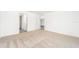 Empty bedroom showcasing neutral carpeting and doors to other rooms at 3736 Bergamot St, Lake Alfred, FL 33850