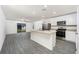Bright kitchen with stainless steel appliances, center island, and open floor plan at 3736 Bergamot St, Lake Alfred, FL 33850