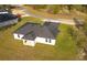 Aerial view showcases the modern single-Gathering home's dark roof and well-maintained lawn at 12921 Sw 64Th Terr Rd, Ocala, FL 34473