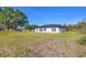 Home's backyard with healthy green lawn and a covered porch at 12921 Sw 64Th Terr Rd, Ocala, FL 34473