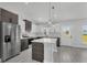 Bright kitchen boasts stainless steel appliances, a center island with a white countertop, and a door to the outside at 12921 Sw 64Th Terr Rd, Ocala, FL 34473