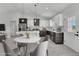 Modern kitchen with dining area, stainless steel appliances, and an island, perfect for entertaining at 12921 Sw 64Th Terr Rd, Ocala, FL 34473