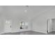 Open-concept living room with a front door and large windows providing natural light at 12921 Sw 64Th Terr Rd, Ocala, FL 34473