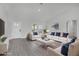 Cozy living room with comfortable seating, a modern TV, and ample natural light from the windows at 12921 Sw 64Th Terr Rd, Ocala, FL 34473