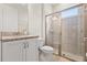 Bathroom featuring a granite countertop, glass enclosed shower, and modern fixtures, creating a clean and stylish space at 321 Auburn Ave, Kissimmee, FL 34747