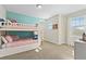 Bright bedroom featuring a charming white bunk bed, soft pink bedding, and natural light from a window at 321 Auburn Ave, Kissimmee, FL 34747