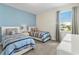 Bright bedroom with carpet, two beds, and a large window letting in natural light at 321 Auburn Ave, Kissimmee, FL 34747